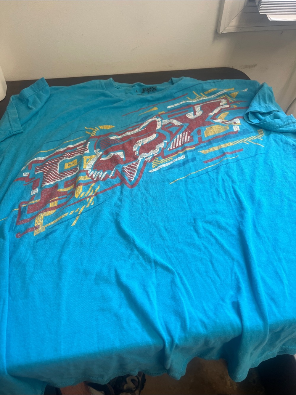 Fox Turquoise Short Sleeve Graphic Tee with Red and Yellow Logo